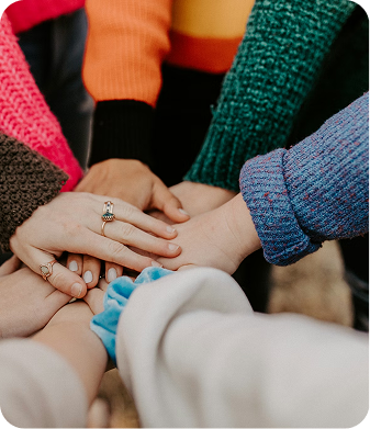 Team members stacking hands together